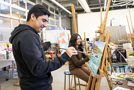 Adult art student working quietly in a studio